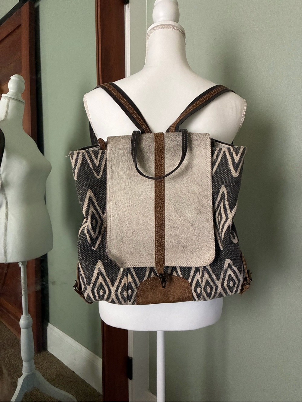 Canvas saddle with hide accent backpack